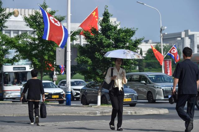 The national flags of North Korea and China are displayed on a street in Pyongyang on June 8, 2026. Chinese President Xi Jinping arrived in Pyongyang on June 8, state news agency Xinhua reported, for his first official visit to North Korea since 2019. (Photo by KIM Won Jin / AFP)