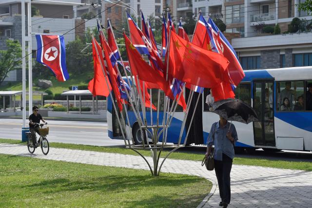 The national flags of North Korea and China are displayed on a street in Pyongyang on June 8, 2026. Chinese President Xi Jinping arrived in Pyongyang on June 8, state news agency Xinhua reported, for his first official visit to North Korea since 2019. (Photo by KIM Won Jin / AFP)