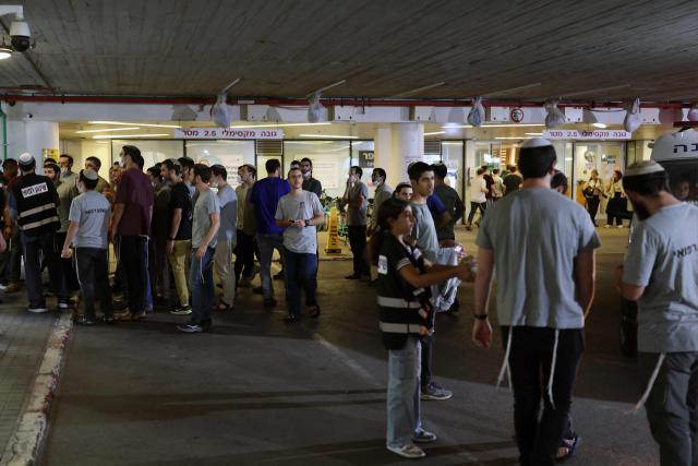 People gather at a holding area before transferring patients to an underground facility of a hospital in Tel Aviv on June 8, 2026. Israel and Iran traded fire on June 8 hours after US President Donald Trump called on his Israeli counterpart to refrain from retaliating against Tehran's barrage of missiles. (Photo by Ilia YEFIMOVICH / AFP)