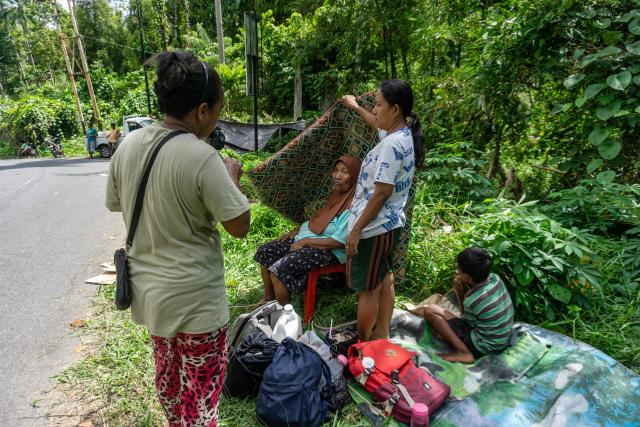 Residents evacuate to higher ground following a tsunami warning issued after a magnitude 7.8 earthquake off the southern Philippines, at Peta Timur village in Sangihe Islands Regency, Indonesia's North Sulawesi province on June 8, 2026. The quake which killed at least three people in the Philippines triggered evacuation warnings for coastal areas of neighbouring Indonesia and Malaysia, with Jakarta's meteorological agency subsequently lifting its alert. (Photo by Stenly Pontolawokang / AFP)