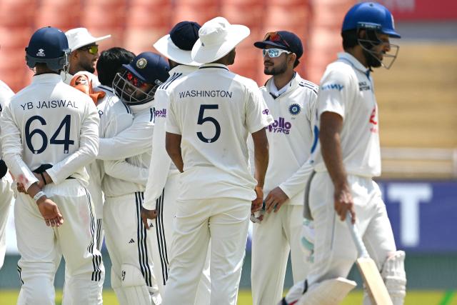 Indian cricket team players celebrate the dismissal of Afghanistan's Sharafuddin Ashraf (R) during the third day of the only Test cricket match between India and Afghanistan at the Maharaja Yadavindra Singh International Cricket Stadium on the outskirts of Chandigarh on June 8, 2026. (Photo by Shammi MEHRA / AFP)