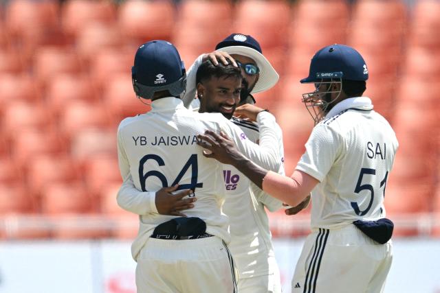 India's Manav Suthar (C) celebrates with teammates after taking the wicket of Afghanistan's Rahmat Shah during the third day of the only Test cricket match between India and Afghanistan at the Maharaja Yadavindra Singh International Cricket Stadium on the outskirts of Chandigarh on June 8, 2026. (Photo by Shammi MEHRA / AFP)