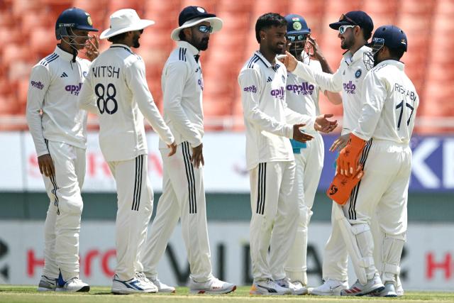 India's Manav Suthar (C) celebrates with teammates after taking the wicket of Afghanistan's Rahmat Shah during the third day of the only Test cricket match between India and Afghanistan at the Maharaja Yadavindra Singh International Cricket Stadium on the outskirts of Chandigarh on June 8, 2026. (Photo by Shammi MEHRA / AFP)