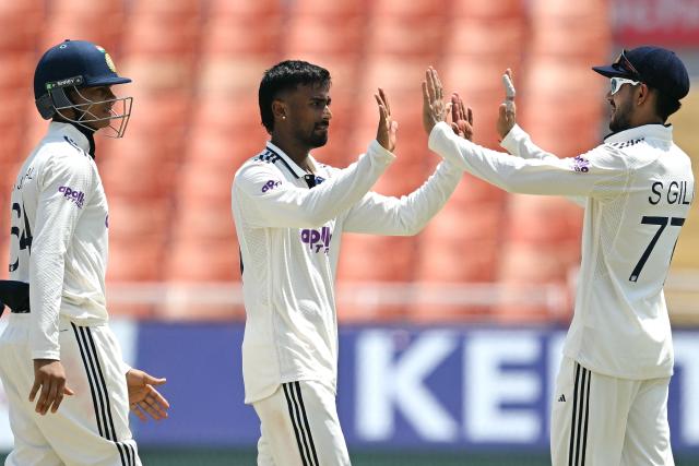India's Manav Suthar (C) celebrates with teammates after taking the wicket of Afghanistan's Mohammad Saleem during the third day of the only Test cricket match between India and Afghanistan at the Maharaja Yadavindra Singh International Cricket Stadium on the outskirts of Chandigarh on June 8, 2026. (Photo by Shammi MEHRA / AFP)