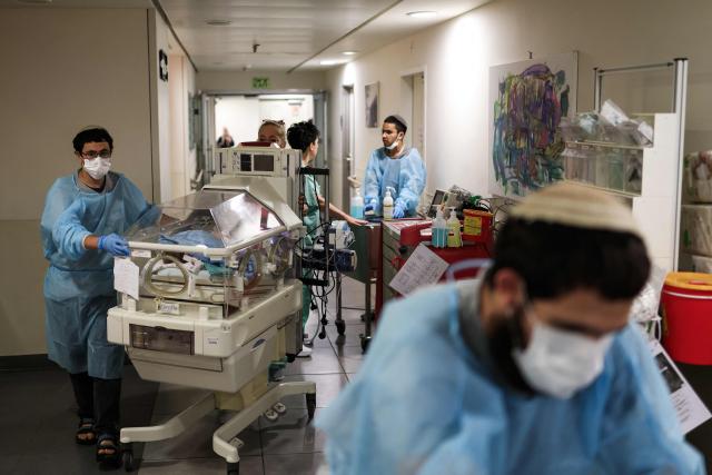 Hospital staff move a baby in an incubator to an underground facility for safety in Tel Aviv on June 8, 2026, after sirens sounded following Iranian attacks. Israel and Iran traded fire on June 8, seriously testing a fragile truce and threating hopes for a deal to end the Middle East war. (Photo by Ilia YEFIMOVICH / AFP)