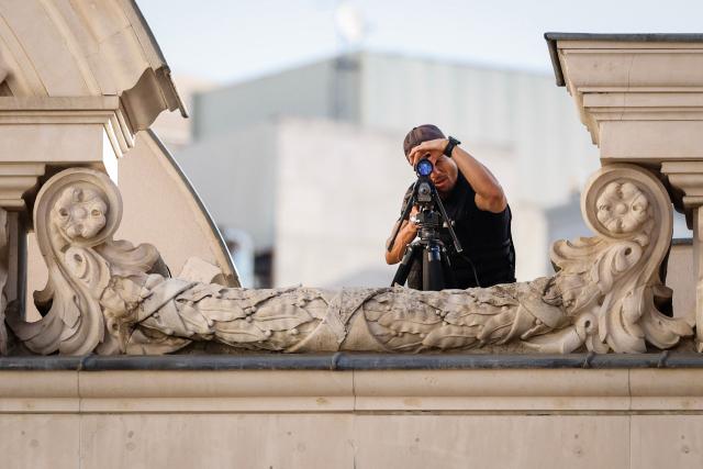 A security official looks through a scope on the roof of the Congress of Deputies prior to the arrival of  Pope Leo XIV who is scheduled to meet with members of Spain's Parliament in Madrid on June 8, 2026. Pope Leo XIV is visiting Spain June 6-12 with stops in Madrid, Barcelona, and the Canary Islands, where he will meet with migrants and organisations dedicated to helping them. (Photo by Oscar DEL POZO / AFP)