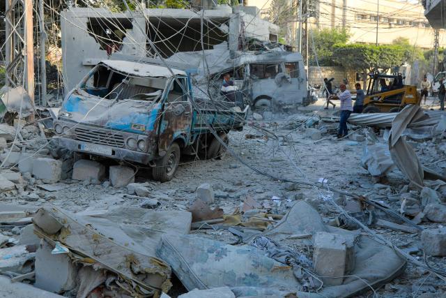 TOPSHOT - Workers clean debris a day after Israeli airstrikes in Tyre on June 8, 2026. Iran and Israel on June 8 attacked each other's territory for the first time since a shaky ceasefire put five weeks of war on hold, sparking fears the escalation could spark a new full-scale conflict. Tehran's strikes followed attacks by Israel against targets of the Iran-backed Lebanese Shia group Hezbollah in the southern suburbs of Beirut. (Photo by KAWNAT HAJU / AFP) / 
