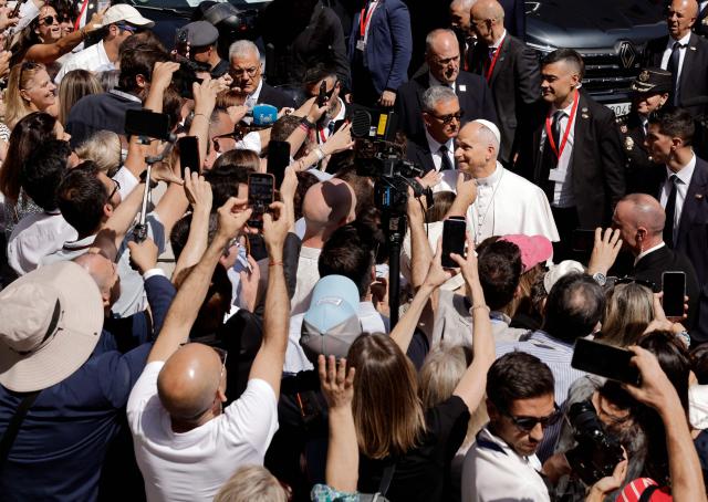 Pope Leo XIV greets people as he leaves the Congress of Deputies after delivering a speech to a joint session of the Spanish Parliament in Madrid on June 8, 2026. Pope Leo XIV is visiting Spain June 6-12 with stops in Madrid, Barcelona, and the Canary Islands, where he will meet with migrants and organisations dedicated to helping them. (Photo by Oscar DEL POZO / AFP)