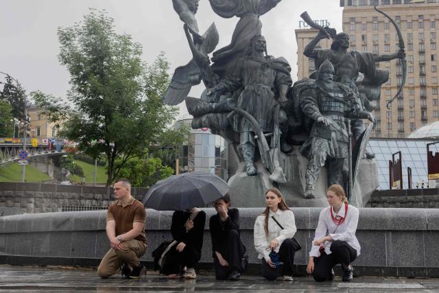 Mourners kneel during the funeral ceremony of Yaroslav Varnak, 23 years old a serviceman who was killed in action in Kyiv on June 8, 2026, amid the Russian invasion of Ukraine. (Photo by Tetiana DZHAFAROVA / AFP)