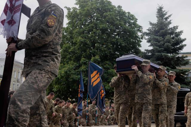 Ukrainian service men carry the coffin of Yaroslav Varnak, 23 years old a serviceman who was killed in action, during the funeral ceremony in Kyiv on June 8, 2026, amid the Russian invasion of Ukraine. (Photo by Tetiana DZHAFAROVA / AFP)