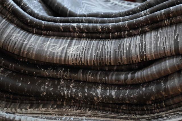 This photograph shows rubber sheets used in the manufacture of tyres displayed at the Goodyear tyre factory ahead of a visit of French President, in Amiens, northern France on June 8, 2026. (Photo by Ludovic MARIN / POOL / AFP)