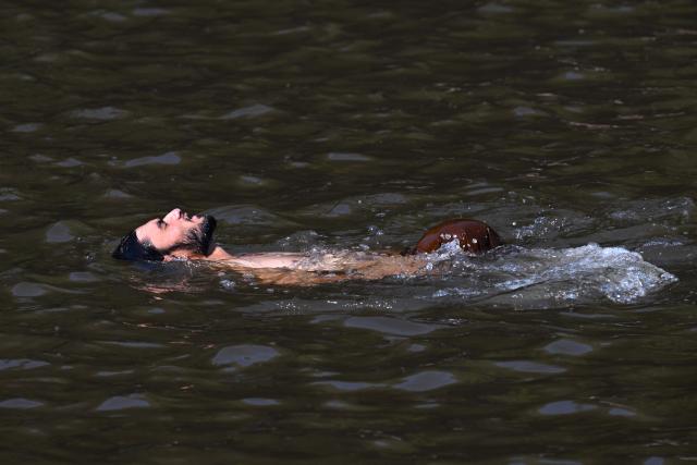 A man cools off in stream water during a hot summer day on the outskirts of Islamabad on June 8, 2026. Pakistan's Meteorological Department has forecast hot and dry weather in most parts of the country with the highest temperatures recorded at 46 celsius in the southern Sindh province. (Photo by Aamir QURESHI / AFP)