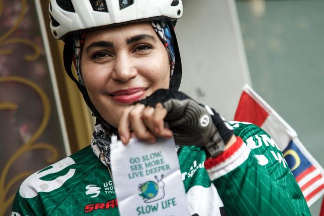 Iranian cyclist Arezoo Eskandari, 35, who is traveling across Asia, poses after arriving in Jakarta on June 8, 2026. Eskandari has cycled thousands of kilometers across Asia, aiming to promote peace, friendship and cultural understanding. (Photo by Aditya Irawan / AFP)