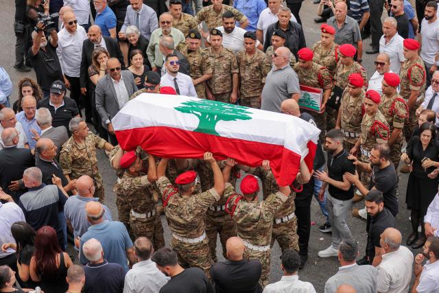 Mourners carry the coffin of Lebanese army captain Elie Khoury, who was killed by Israeli bombardment, during his funeral in his home village of Kfar Jarra near Jezzine in southern Lebanon on June 8, 2026. An Israeli strike in southern Lebanon killed three soldiers, Beirut's military said on June 6, as its chief travelled to Pakistan to meet with a key mediator in efforts to end the Middle East war. Israel has launched an operation in Lebanon to root out the Tehran-backed armed group Hezbollah, which drew Lebanon into the wider Middle East war by launching missiles on behalf of its sponsor. (Photo by MAHMOUD ZAYYAT / AFP)