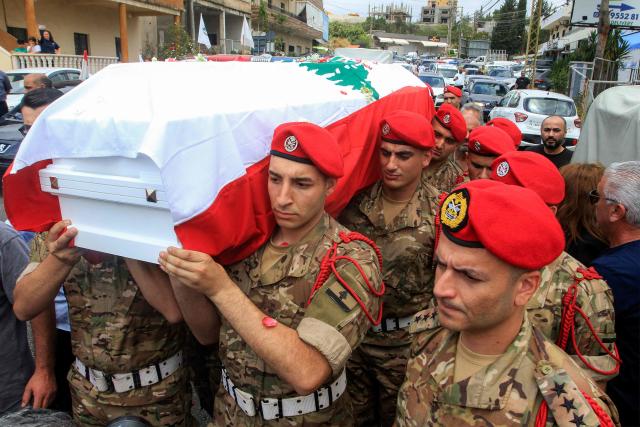 Lebanese army soldiers carry the coffin of captain Elie Khoury, who was killed by Israeli bombardment, during his funeral in his home village of Kfar Jarra near Jezzine in southern Lebanon on June 8, 2026. An Israeli strike in southern Lebanon killed three soldiers, Beirut's military said on June 6, as its chief travelled to Pakistan to meet with a key mediator in efforts to end the Middle East war. Israel has launched an operation in Lebanon to root out the Tehran-backed armed group Hezbollah, which drew Lebanon into the wider Middle East war by launching missiles on behalf of its sponsor. (Photo by Mahmoud ZAYYAT / AFP)