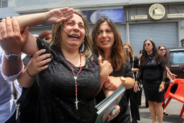 EDITORS NOTE: Graphic content / Rosette Tannous, wife of Lebanese army captain Elie Khoury who was killed by Israeli bombardment, salutes as mourners carry her husband's coffin past during the funeral in his home village of Kfar Jarra near Jezzine in southern Lebanon on June 8, 2026. An Israeli strike in southern Lebanon killed three soldiers, Beirut's military said on June 6, as its chief travelled to Pakistan to meet with a key mediator in efforts to end the Middle East war. Israel has launched an operation in Lebanon to root out the Tehran-backed armed group Hezbollah, which drew Lebanon into the wider Middle East war by launching missiles on behalf of its sponsor. (Photo by Mahmoud ZAYYAT / AFP)