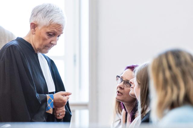 Complainant Jennifer C. (C) speaks with Fabienne Roy-Nansion (L), lawyer for the civil party, before the trial of Jerome P. charged with rape and violence in a context of coercive control and polygamy at the Saint-Omer Judicial Court, in Saint-Omer, northern France, on June 8, 2026. The trial of a man accused of ruling his home with terror for two decades, where he lived with three women and their children, opened on June 8, 2026, in the Pas-de-Calais. The defendant denies any violence but acknowledges a “bizarre” family dynamic. (Photo by Sameer Al-DOUMY / AFP)