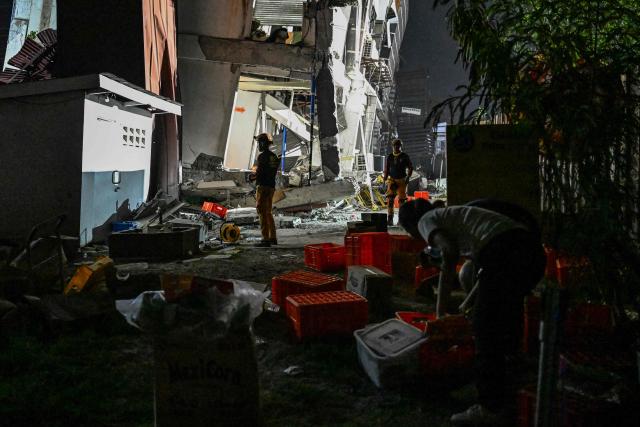 Responders assess a collapsed building after a 7.8 magnitude earthquake in General Santos City on June 8, 2026. The earthquake in the southern Philippines killed at least 31 people, according to provincial authorities, after toppling buildings and sparking tsunami warnings across the region. (Photo by Jam STA ROSA / AFP)
