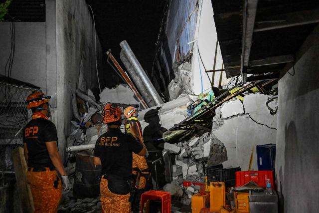 Responders assess a collapsed building after a 7.8 magnitude earthquake in General Santos City on June 8, 2026. The earthquake in the southern Philippines killed at least 31 people, according to provincial authorities, after toppling buildings and sparking tsunami warnings across the region. (Photo by Jam STA ROSA / AFP)