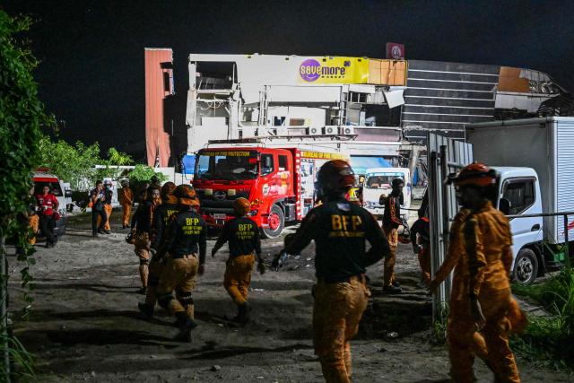 Responders assess a collapsed building after a 7.8 magnitude earthquake in General Santos City on June 8, 2026. The earthquake in the southern Philippines killed at least 31 people, according to provincial authorities, after toppling buildings and sparking tsunami warnings across the region. (Photo by Jam STA ROSA / AFP)