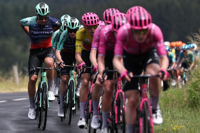 Decathlon CMA CGM Team's Swiss rider Stefan Bissegger (L) adjusts his jersey as he cycles with the pack of riders during the 2nd stage of the Tour Auvergne-Rhone-Alpes cycling race (formerly known as the Criterium du Dauphine), 234,3km between Saint-Martin-Le-Vinoux in the French Alps and Le Puy-en-Velay near the Massif Central, on June 8, 2026. (Photo by Anne-Christine POUJOULAT / AFP)