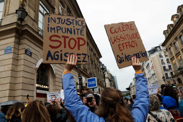 People march for an unauthorised demonstration towards Place Vendome outside the French Justice Ministry in Paris on June 8, 2026, at the call of the Mouv'Enfants collective and other organisations, to demand a law against violence on minors, following the death of Lyhanna, an 11-year-old girl found dead on June 4 after being reported missing on May 29 in southwestern France, on June 8, 2026. The placards read : "Injustice, Impunity, Stop, Act" (L) and "Anger, Weariness, Dread, What are you waiting for?". (Photo by GEOFFROY VAN DER HASSELT / AFP)