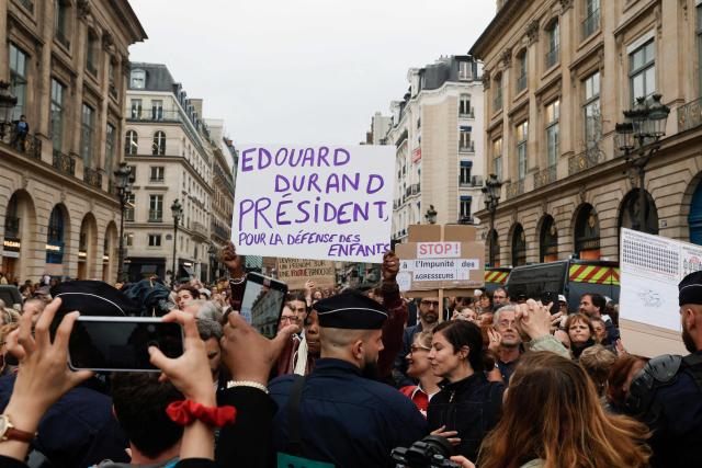French director and screennwriter Judith Godreche (C-R) and French actress Anna Mouglalis (next to Godreche) take part in an unauthorised demonstration at Place Vendome outside the French Justice Ministry in Paris on June 8, 2026, at the call of the Mouv'Enfants collective and other organisations, to demand a law against violence on minors, following the death of Lyhanna, an 11-year-old girl found dead on June 4 after being reported missing on May 29 in southwestern France, on June 8, 2026. The placards refers to French magistrate Edouard Durand, known to the public for his role leading the Ciivise, the Independent Commission on Incest and Sexual Violence Against Children. (Photo by GEOFFROY VAN DER HASSELT / AFP)