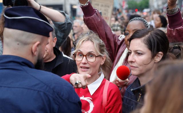 French director and screennwriter Judith Godreche (C) and French actress Anna Mouglalis (R) take part in an unauthorised demonstration at Place Vendome outside the French Justice Ministry in Paris on June 8, 2026, at the call of the Mouv'Enfants collective and other organisations, to demand a law against violence on minors, following the death of Lyhanna, an 11-year-old girl found dead on June 4 after being reported missing on May 29 in southwestern France, on June 8, 2026. (Photo by GEOFFROY VAN DER HASSELT / AFP)