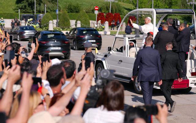 Pope Leo XIV waves to people from the popemobile as he leaves the Almudena Cathedral after leading prayer and devotion to Our Lady of Almudena in Madrid on June 8, 2026. Pope Leo XIV is visiting Spain June 6-12 with stops in Madrid, Barcelona, and the Canary Islands, where he will meet with migrants and organisations dedicated to helping them. (Photo by Cesar MANSO / AFP)