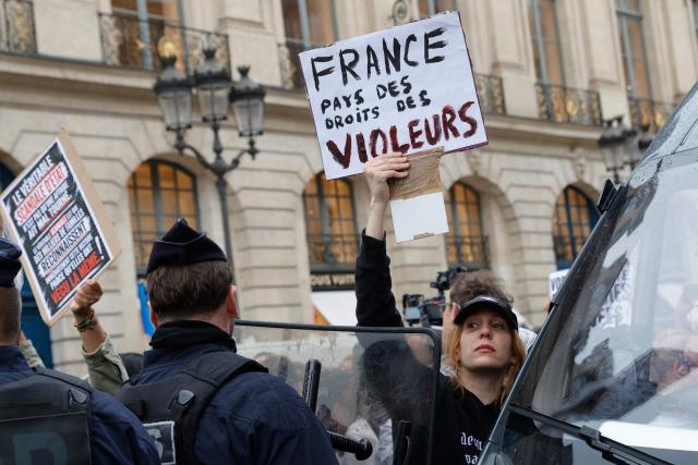 People take part in an unauthorised demonstration near Place Vendome outside the French Justice Ministry in Paris on June 8, 2026, at the call of the Mouv'Enfants collective and other organisations, to demand a law against violence on minors, following the death of Lyhanna, an 11-year-old girl found dead on June 4 after being reported missing on May 29 in southwestern France, on June 8, 2026. The placard reads: "France, land of rapists' rights". (Photo by GEOFFROY VAN DER HASSELT / AFP)