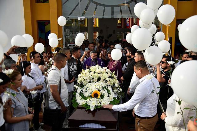 Relatives and friends attend the funeral of slain journalist Cristian Herrera in Cucuta, Colombia, on June 8, 2026. Herrera was killed on June 6, 2026, on the Colombia-Venezuela border, following the death of another journalist attacked by guerrillas nearly a month ago according to the Ombudsman's Office. A hitman riding a motorcycle shot the journalist, who died while being taken to a hospital, according to local media. (Photo by Schneyder Mendoza / AFP)