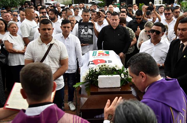 Relatives and friends attend the funeral of slain journalist Cristian Herrera in Cucuta, Colombia, on June 8, 2026. Herrera was killed on June 6, 2026, on the Colombia-Venezuela border, following the death of another journalist attacked by guerrillas nearly a month ago according to the Ombudsman's Office. A hitman riding a motorcycle shot the journalist, who died while being taken to a hospital, according to local media. (Photo by Schneyder Mendoza / AFP)