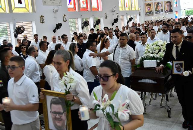 Relatives and friends attend the funeral of slain journalist Cristian Herrera in Cucuta, Colombia, on June 8, 2026. Herrera was killed on June 6, 2026, on the Colombia-Venezuela border, following the death of another journalist attacked by guerrillas nearly a month ago according to the Ombudsman's Office. A hitman riding a motorcycle shot the journalist, who died while being taken to a hospital, according to local media. (Photo by Schneyder Mendoza / AFP)
