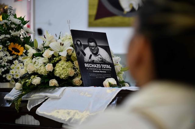 The coffin of slain journalist Cristian Herrera is seen during a funeral ceremony in Cucuta, Colombia, on June 8, 2026. Herrera was killed on June 6, 2026, on the Colombia-Venezuela border, following the death of another journalist attacked by guerrillas nearly a month ago according to the Ombudsman's Office. A hitman riding a motorcycle shot the journalist, who died while being taken to a hospital, according to local media. (Photo by Schneyder Mendoza / AFP)