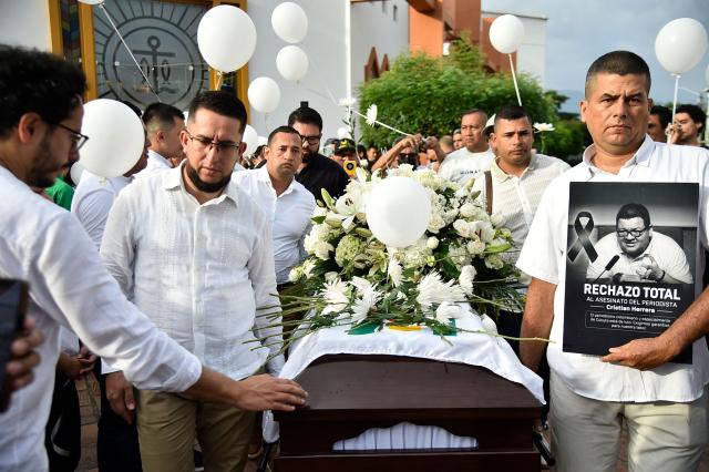 Relatives and friends attend the funeral of slain journalist Cristian Herrera in Cucuta, Colombia, on June 8, 2026. Herrera was killed on June 6, 2026, on the Colombia-Venezuela border, following the death of another journalist attacked by guerrillas nearly a month ago according to the Ombudsman's Office. A hitman riding a motorcycle shot the journalist, who died while being taken to a hospital, according to local media. (Photo by Schneyder Mendoza / AFP)