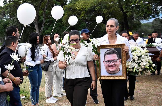 Relatives and friends attend the funeral of slain journalist Cristian Herrera in Cucuta, Colombia, on June 8, 2026. Herrera was killed on June 6, 2026, on the Colombia-Venezuela border, following the death of another journalist attacked by guerrillas nearly a month ago according to the Ombudsman's Office. A hitman riding a motorcycle shot the journalist, who died while being taken to a hospital, according to local media. (Photo by Schneyder Mendoza / AFP)