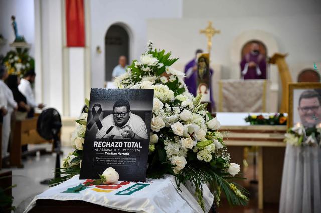 The coffin of slain journalist Cristian Herrera is seen during a funeral ceremony in Cucuta, Colombia, on June 8, 2026. Herrera was killed on June 6, 2026, on the Colombia-Venezuela border, following the death of another journalist attacked by guerrillas nearly a month ago according to the Ombudsman's Office. A hitman riding a motorcycle shot the journalist, who died while being taken to a hospital, according to local media. (Photo by Schneyder Mendoza / AFP)