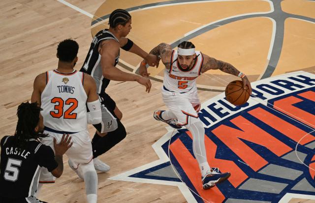 Knicks guard #5 Jose Alvarado controls the ball past Spurs forward #11 Carter Bryant during Game Three of the NBA Finals between the San Antonio Spurs and the New York Knicks at Madison Square Garden in New York on June 8, 2026. (Photo by SAUL LOEB / AFP)