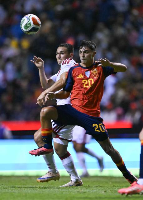 Spain's midfielder #20 Pedri and Peru's midfielder #11 Jairo Velez vie for the ball during the international friendly football match between Peru and Spain at Cuauhtemoc Stadium in Puebla, Mexico, on June 8, 2026. (Photo by CARL DE SOUZA / AFP)