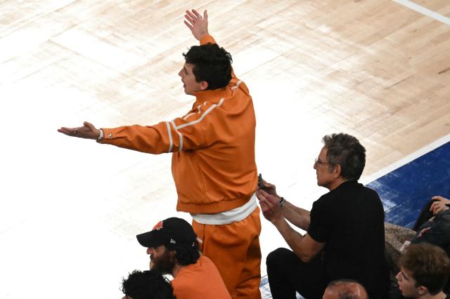 US director Josh Safdie (L), US-French actor Timothee Chalamet (C) and US actor Ben Stiller watch Game Three of the NBA Finals between the San Antonio Spurs and the New York Knicks at Madison Square Garden in New York on June 8, 2026. (Photo by SAUL LOEB / AFP)