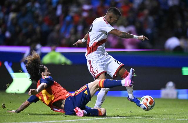 Spain's defender #24 Marc Cucurella attempts to keep Peru's forward #27 Jhonny Vidales from scoring during the international friendly football match between Peru and Spain at Cuauhtemoc Stadium in Puebla, Mexico, on June 8, 2026. (Photo by CARL DE SOUZA / AFP)