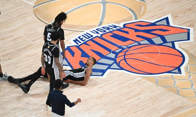 San Antonio Spurs' French forward-center #01 Victor Wembanyama lies on the ground after getting fouled Game Three of the NBA Finals between the San Antonio Spurs and the New York Knicks at Madison Square Garden in New York on June 8, 2026. (Photo by SAUL LOEB / AFP)