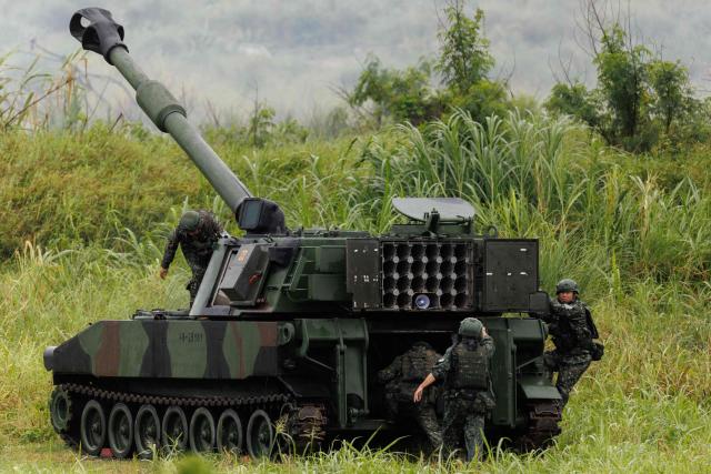 Taiwanese soldiers and their M109A2 self-propelled howitzer take part in a live-fire training exercise in Taichung on June 9, 2026. (Photo by CHENG Yu-chen / AFP)