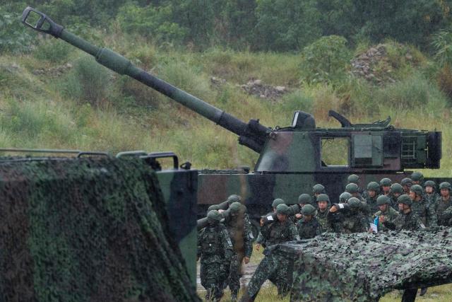 Taiwanese soldiers carry artillery shells for an M109A2 self-propelled howitzer during a live-fire training exercise in Taichung on June 9, 2026. (Photo by CHENG Yu-chen / AFP)