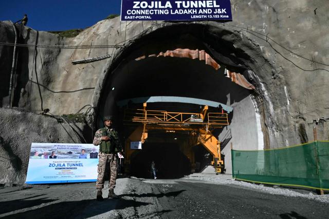 An Indian paramilitary personnel stands guard at the Zojila tunnel, India's longest road tunnel project connecting Jammu and Kashmir state with the Ladakh region on June 9, 2026. (Photo by TAUSEEF MUSTAFA / AFP)
