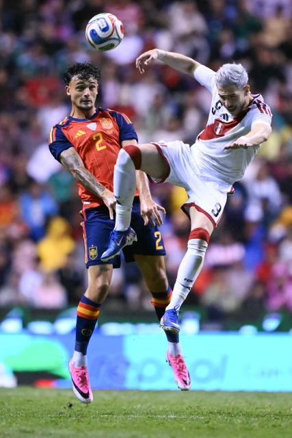 Spain's defender #02 Marc Pubill and Peru's forward #09 Adrian Ugarriza vie for the ball during the international friendly football match between Peru and Spain at Cuauhtemoc Stadium in Puebla, Mexico, on June 8, 2026. (Photo by CARL DE SOUZA / AFP)