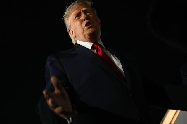 US President Donald Trump speaks to the press before boarding Air Force One prior to departure from John F. Kennedy International Airport, in New York, on June 8, 2026. Trump is returning to the White House after attending Game Three of the NBA Finals. (Photo by SAUL LOEB / AFP)