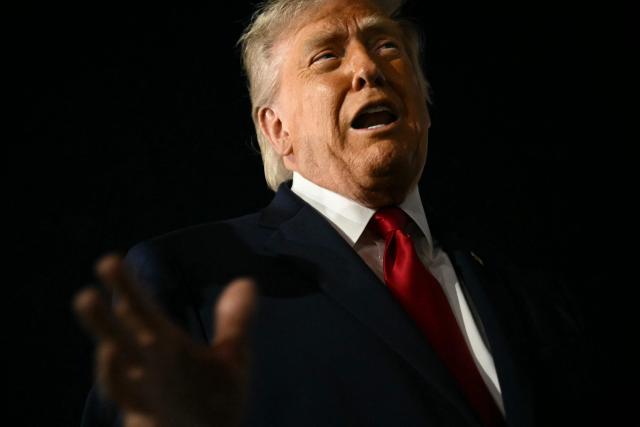 US President Donald Trump speaks to the press before boarding Air Force One prior to departure from John F. Kennedy International Airport, in New York, on June 8, 2026. Trump is returning to the White House after attending Game Three of the NBA Finals. (Photo by SAUL LOEB / AFP)