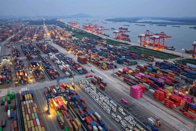 Containers and ships are seen at the port in Nanjing, in China’s eastern Jingsu province early on June 9, 2026. China's exports to the United States surged 35.4 percent year-on-year last month, official data showed on June 9, 2026, weeks after President Donald Trump visited Beijing with trade high on the agenda. (Photo by CN-STR / AFP) / China OUT