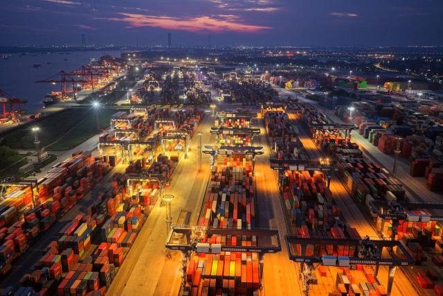 Shipping containers are seen at the port in Nanjing, in China’s eastern Jingsu province early on June 9, 2026. China's exports to the United States surged 35.4 percent year-on-year last month, official data showed on June 9, 2026, weeks after President Donald Trump visited Beijing with trade high on the agenda. (Photo by CN-STR / AFP) / China OUT
